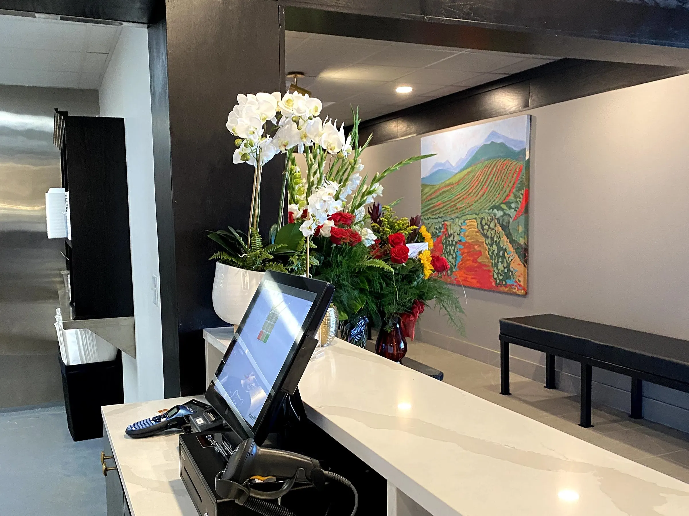 The front counter at Popi's in Benton, Kentucky, with a Propel POS touchscreen station, cash drawer, barcode scanner and card reader