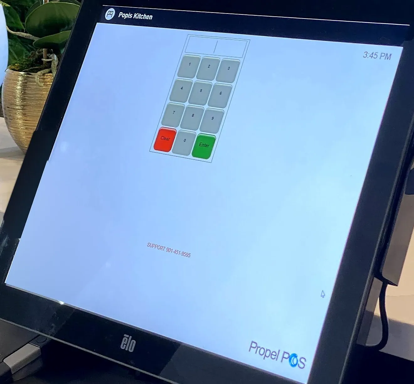 Propel POS sign-in screen on an Elo touchscreen at Popi's in Benton, Kentucky, with the support number 901-451-9595 printed below the keypad